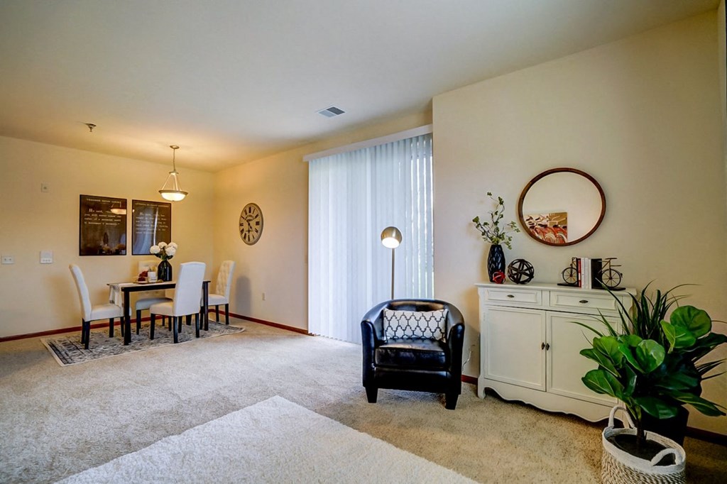 a living room and dining room with a table and chairs