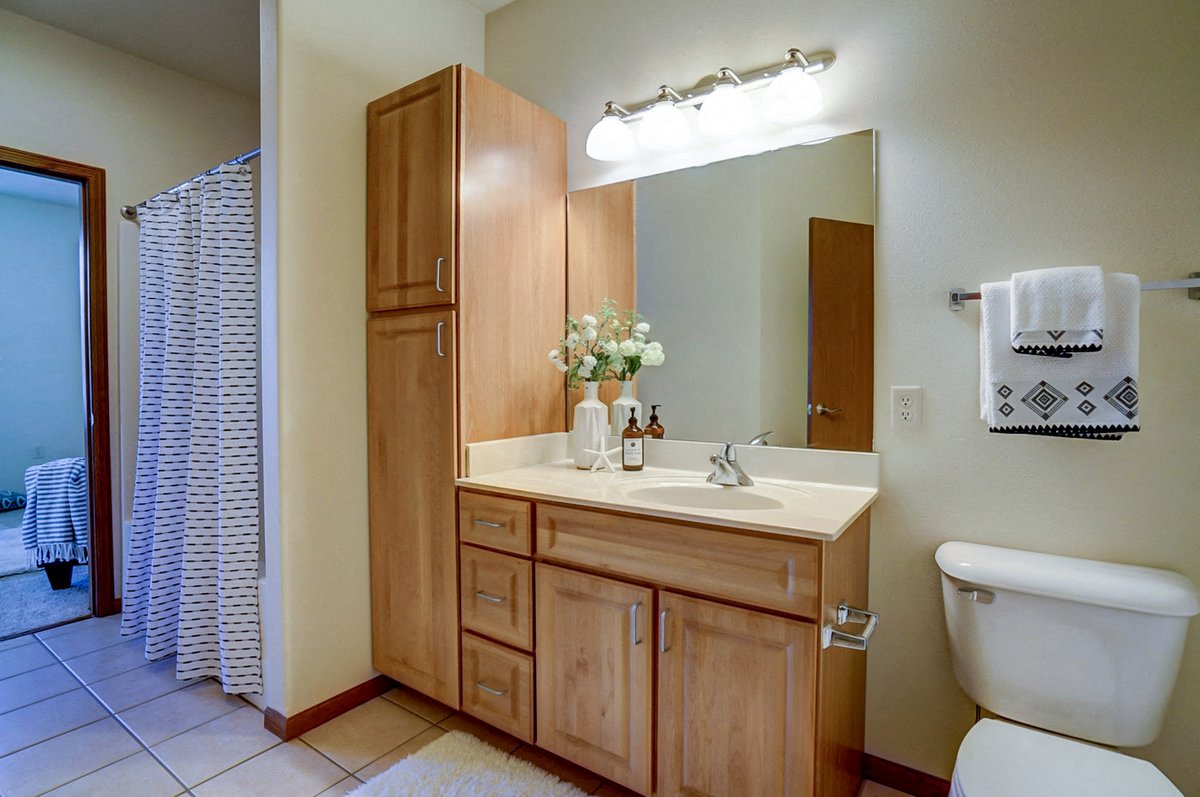 a bathroom with a sink and a toilet and a mirror