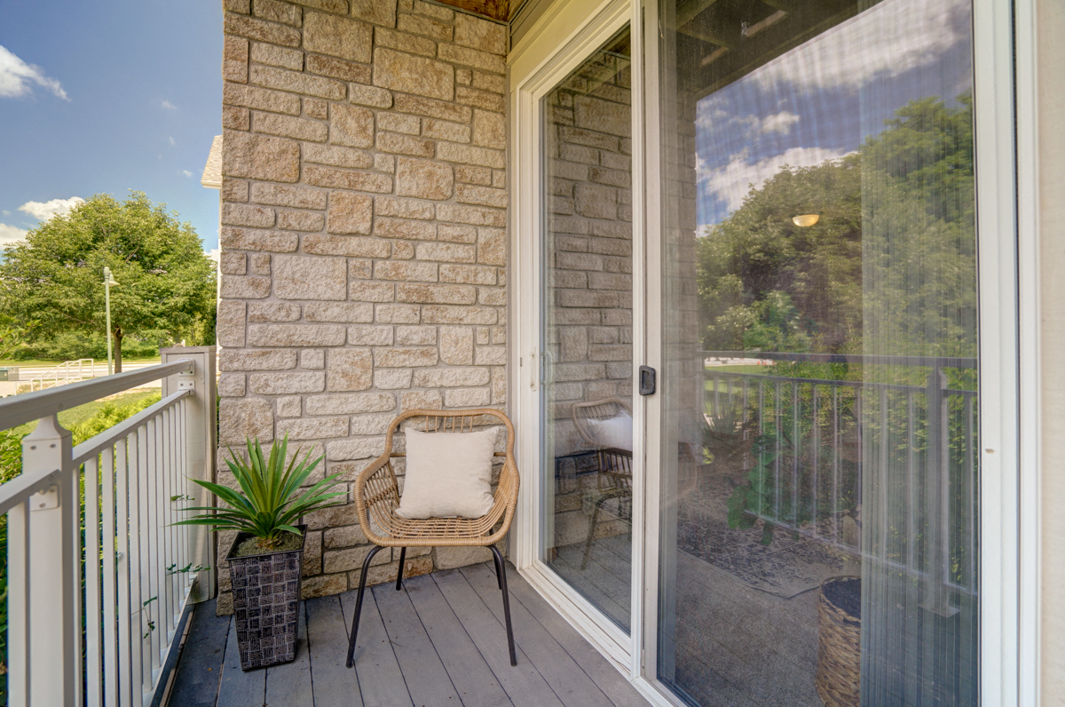 a porch with a chair and a glass door