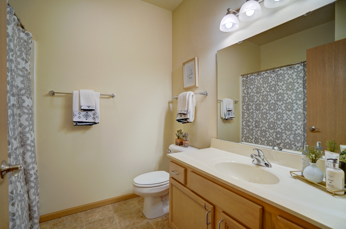 a bathroom with a sink and a toilet and a shower