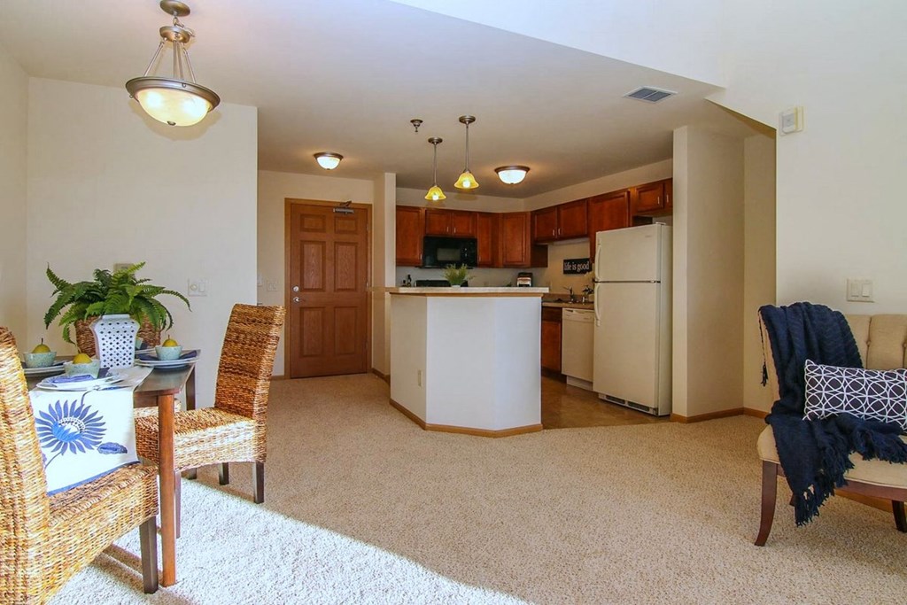 a living room and kitchen with a table and chairs