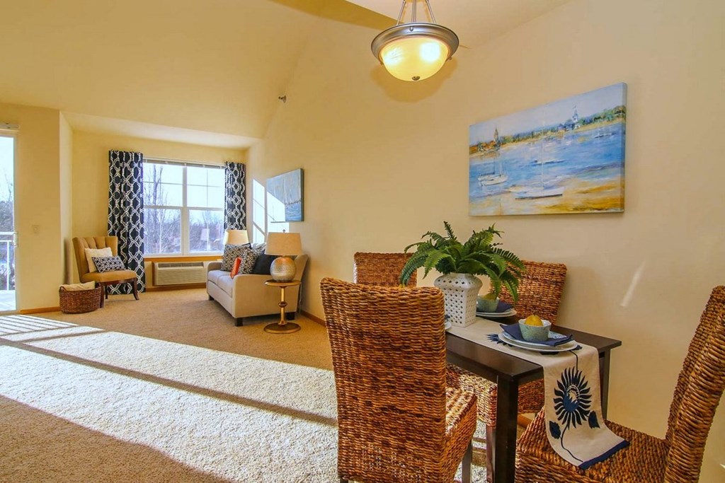 a living room with a table and chairs and a couch