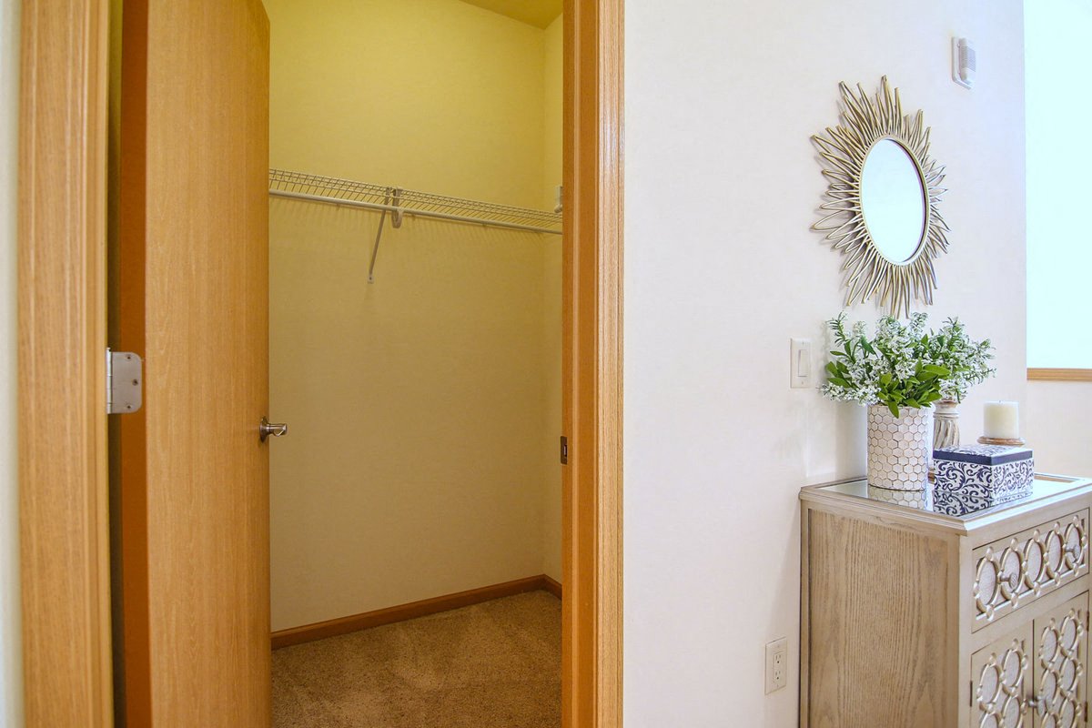 a bathroom with a closet and a mirror on the wall