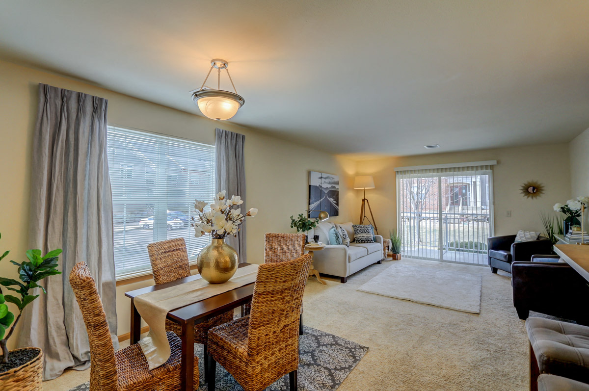 a living room and dining room with a couch and a table