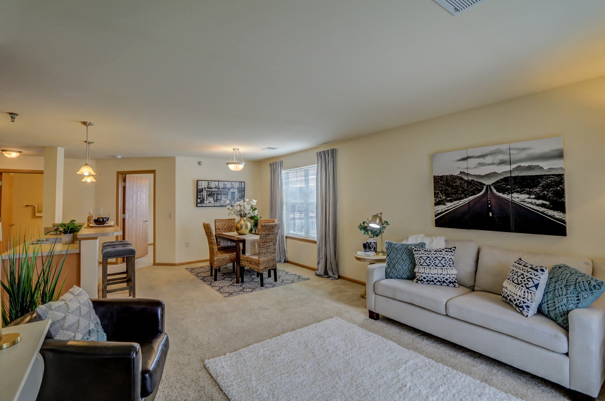 a living room with a couch and a chair and a table