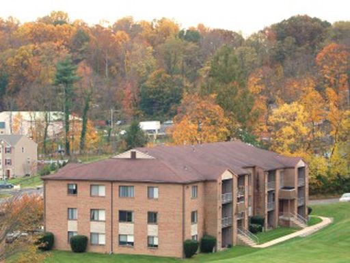 a large brick building with trees in the background