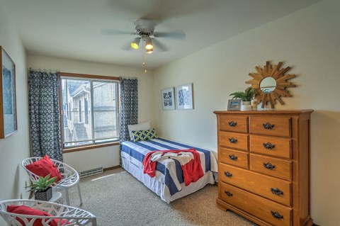 a bedroom with a bed and a dresser