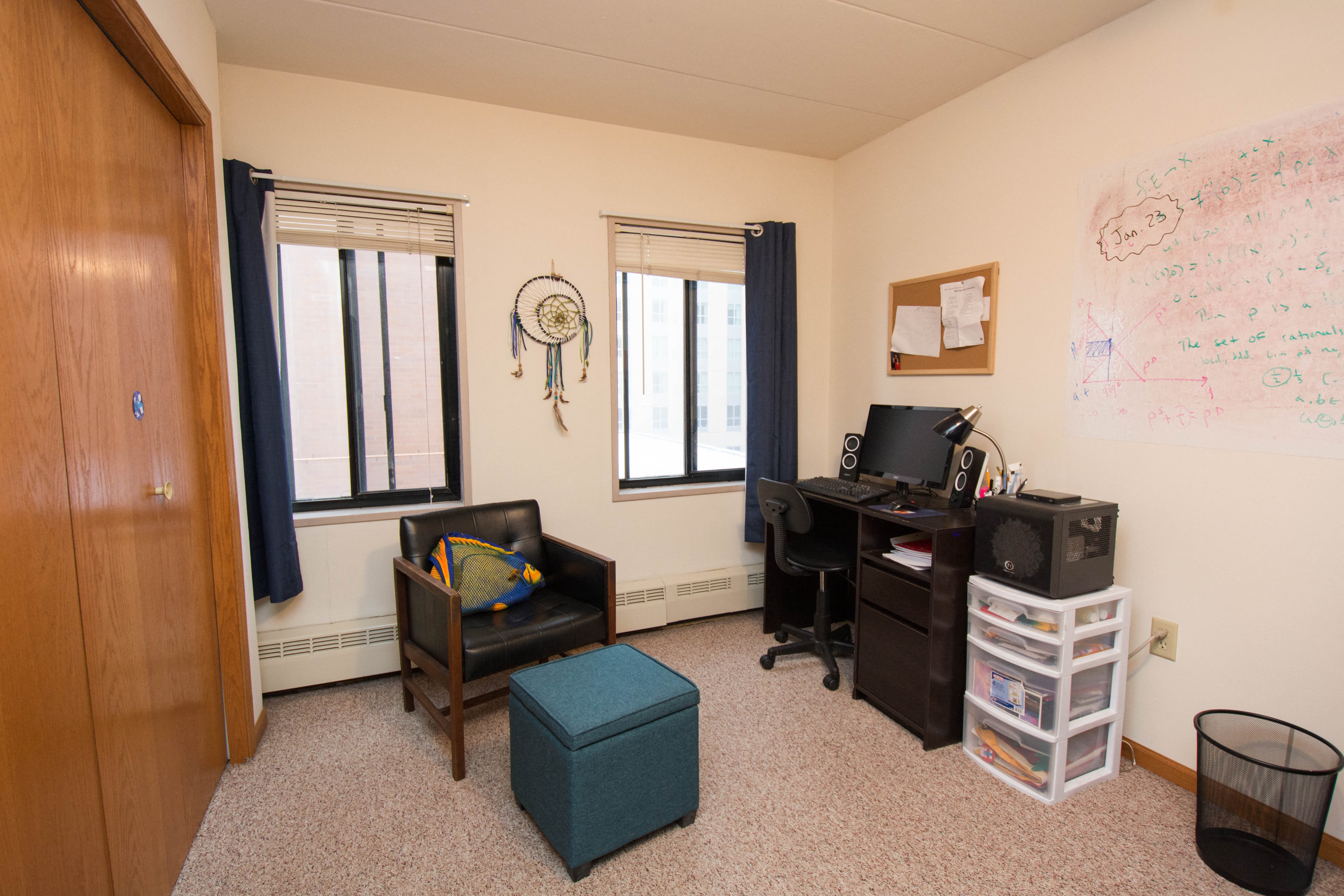 a room with a desk and a chair and a window