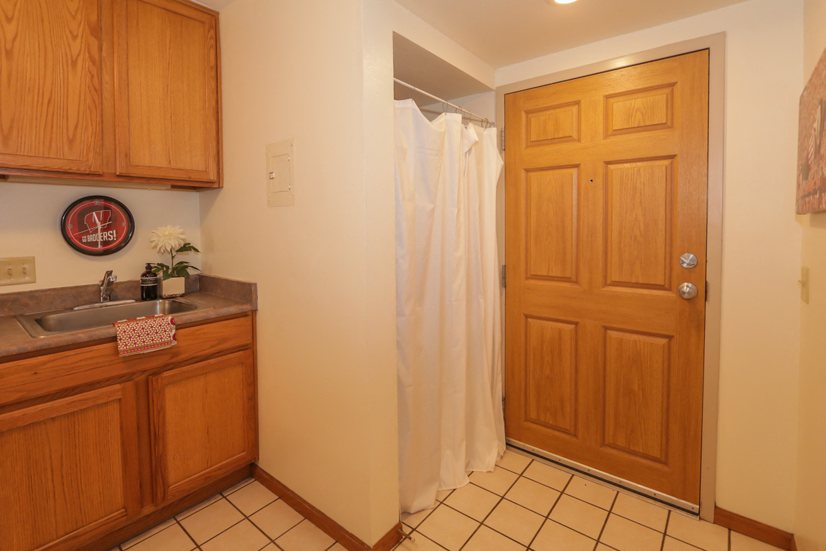 a bathroom with a shower and a sink and a door