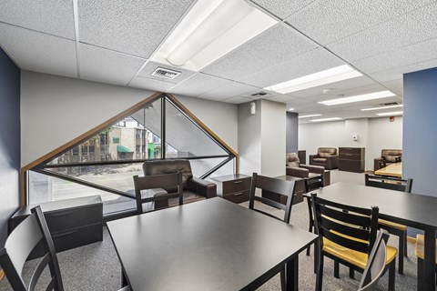 A conference room with a long table and chairs.