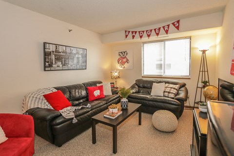 a living room with leather couches and a coffee table