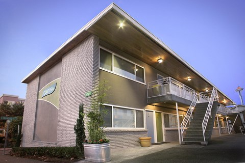 the exterior of a building with a staircase and a balcony