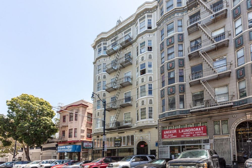 a large apartment building on a busy city street