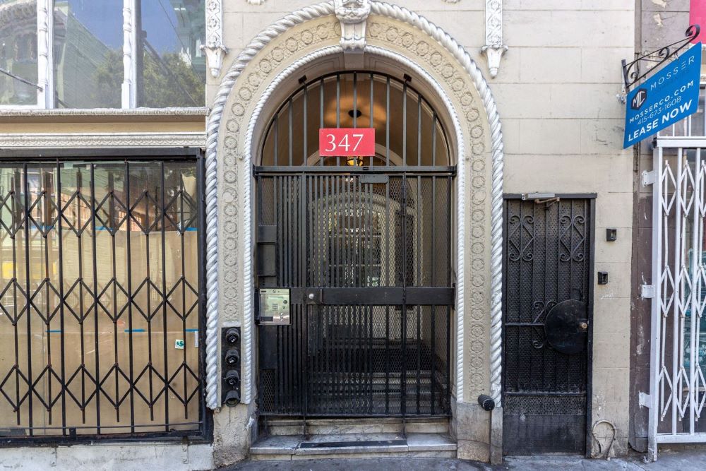 an ornate door with a sign on it in front of a building
