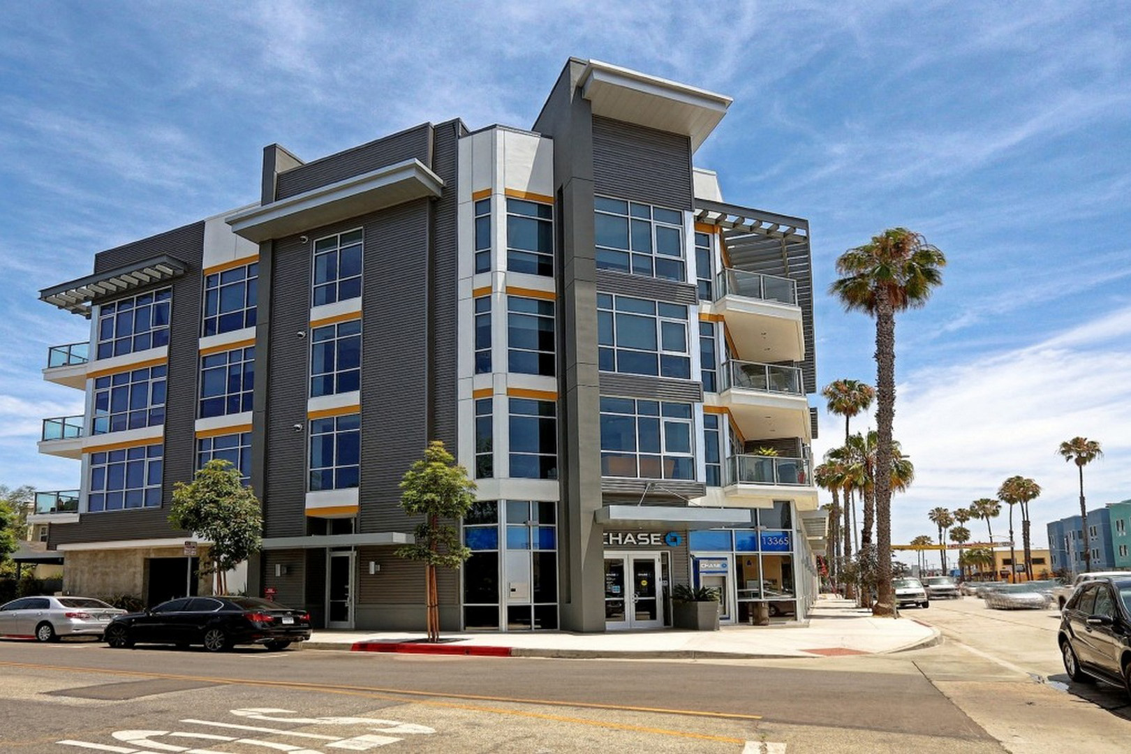 A modern multi-story building with a blue and white color scheme and a HASBROS sign on the front.