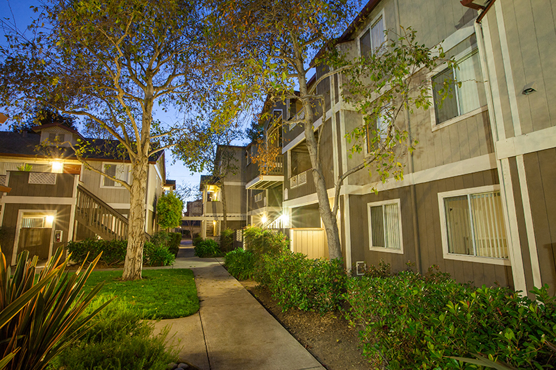 Apartments in Newark for Rent-Alderwood Park-Outside Building with Paved Walkways, Greenery, and Lighting