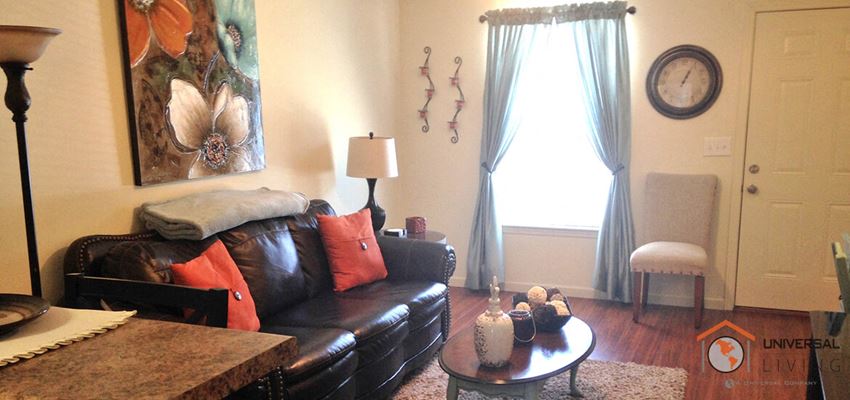 a living room with a leather couch and a coffee table