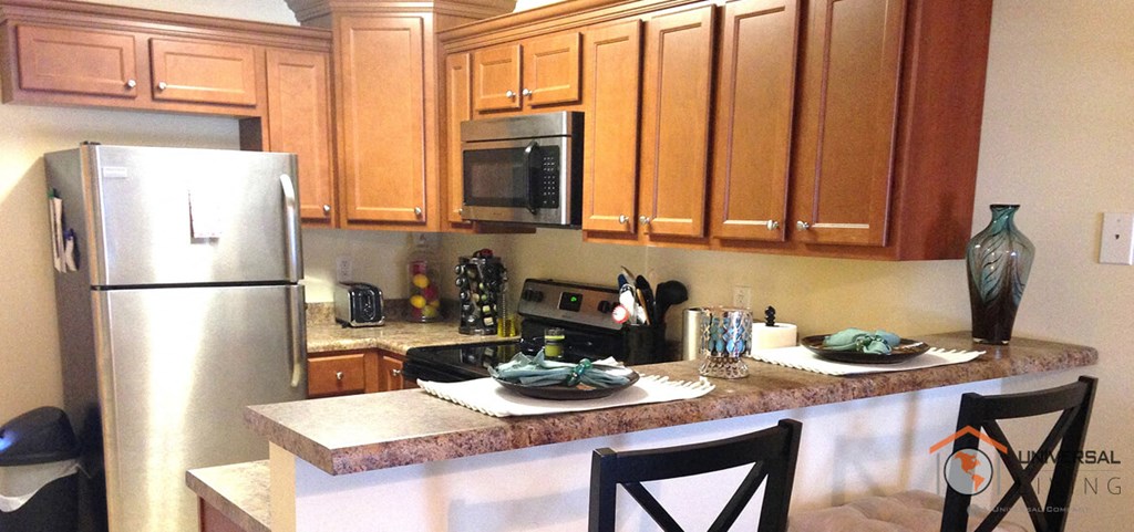 a kitchen with stainless steel appliances and wooden cabinets