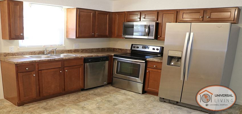 a kitchen with stainless steel appliances and wooden cabinets