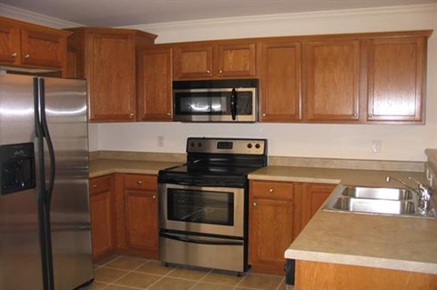 a kitchen with stainless steel appliances and wooden cabinets