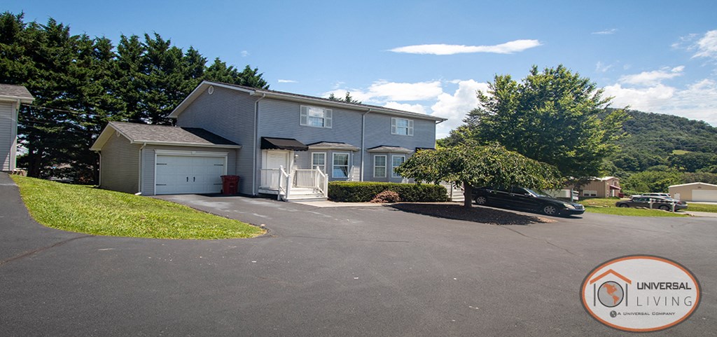 a house with a driveway and a car parked in front of it