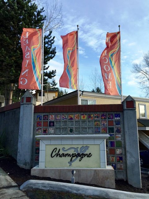 the sign in front of a building with flags on top of it