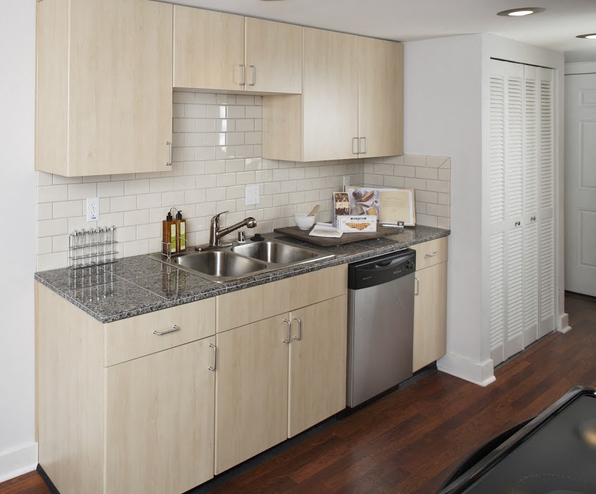 A kitchen with wooden cabinets and a granite countertop.