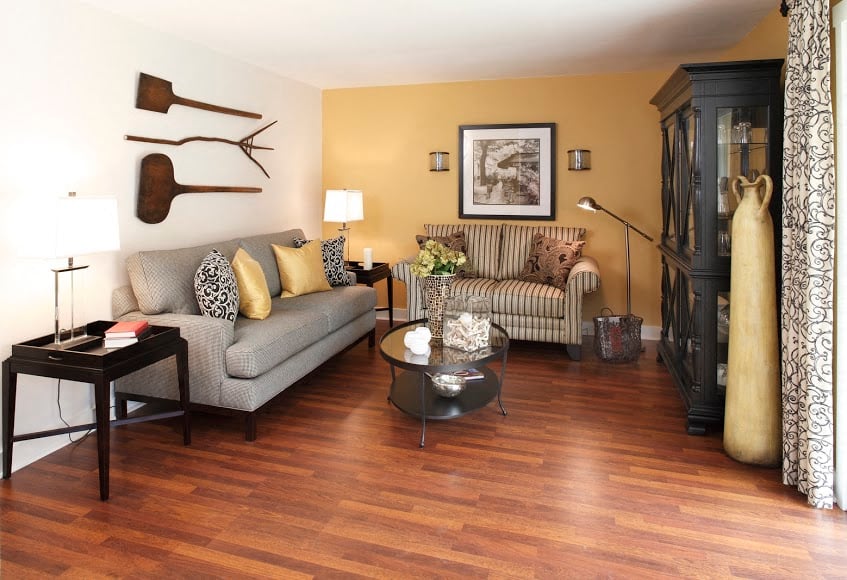 A living room with a grey couch and a coffee table.