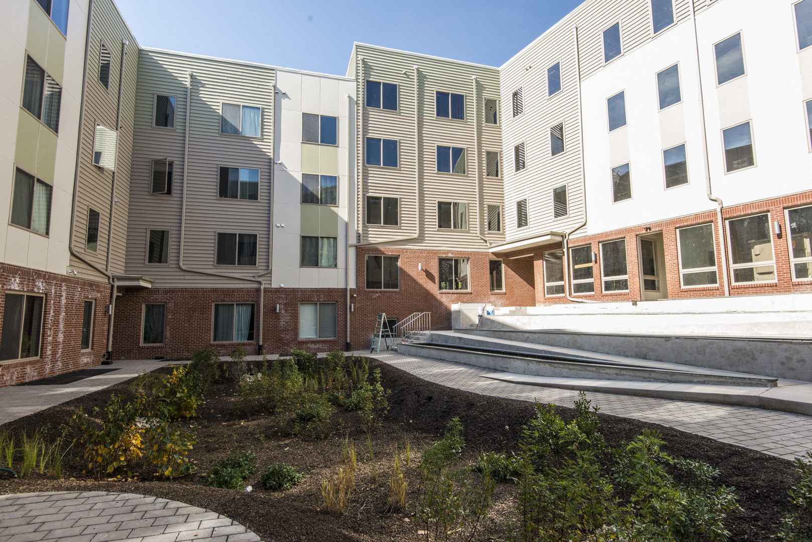an exterior view of an apartment building with stairs
