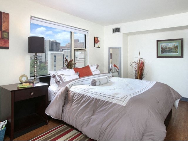Model apartment bedroom featuring oversized windows.