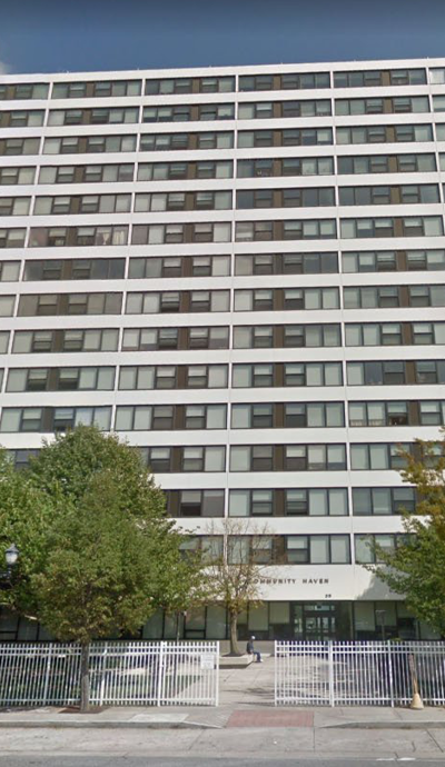 a tall building with trees in front of it