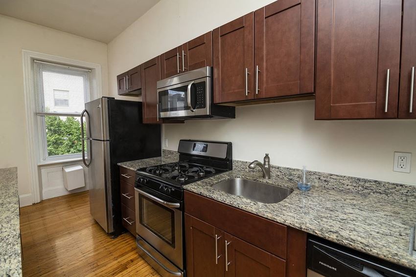 a kitchen with stainless steel appliances and granite counter tops