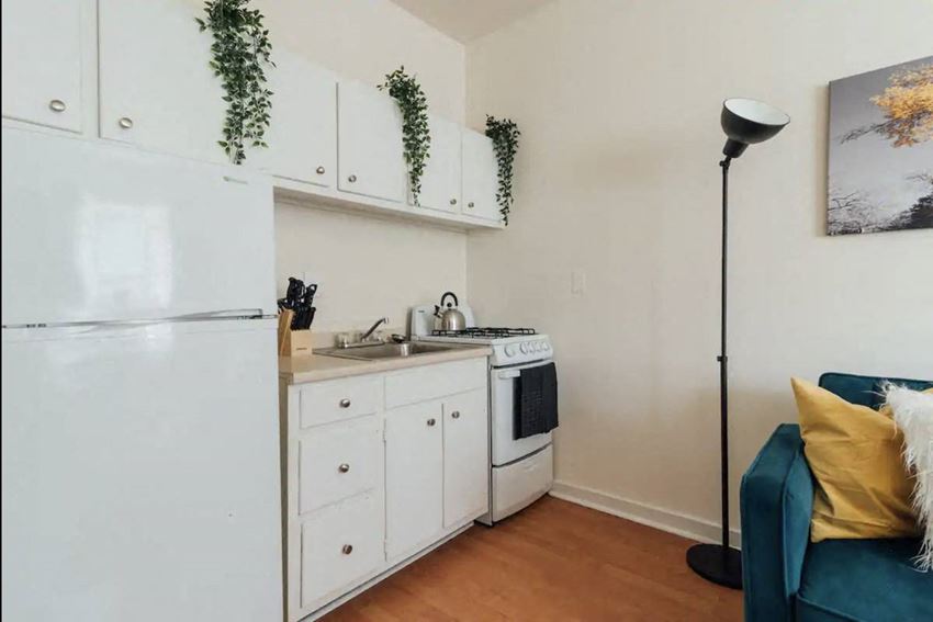 a small kitchen with a refrigerator and a stove and a sink