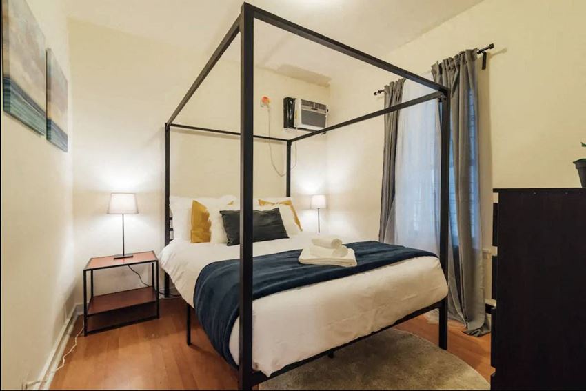 a bedroom with a bed and a canopy bed