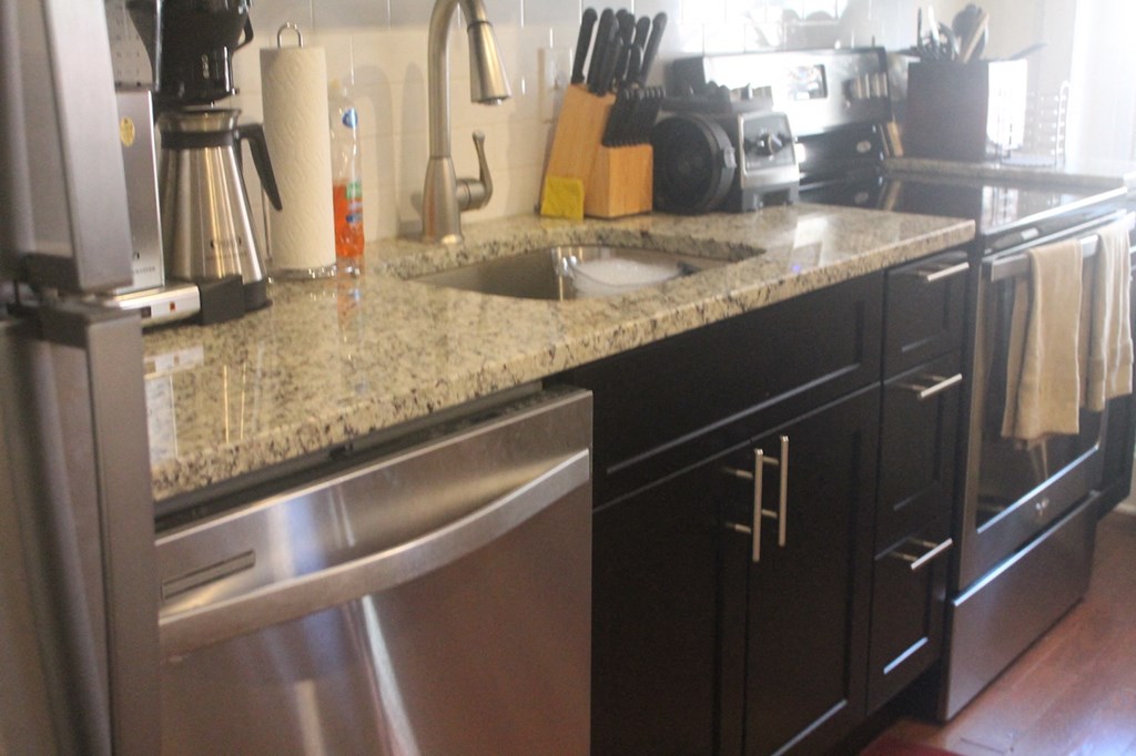 a kitchen with granite counter tops and stainless steel appliances