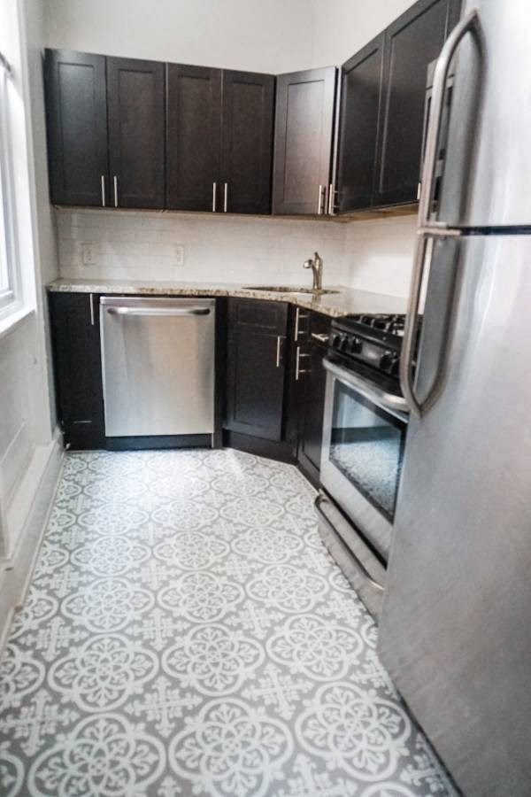 a small kitchen with a refrigerator and a stove