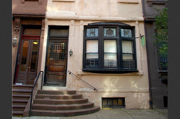 a building with stairs and a window and a door