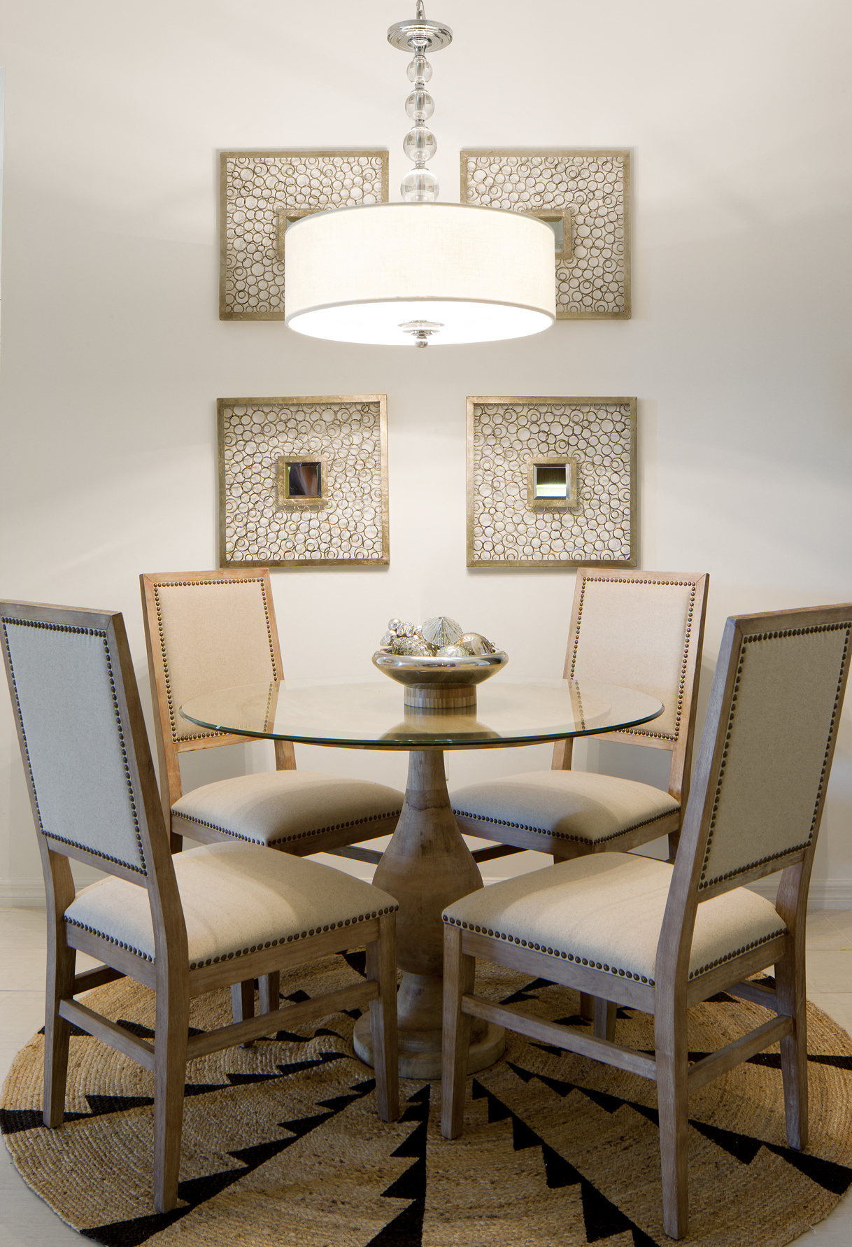 a dining room with a glass table and chairs