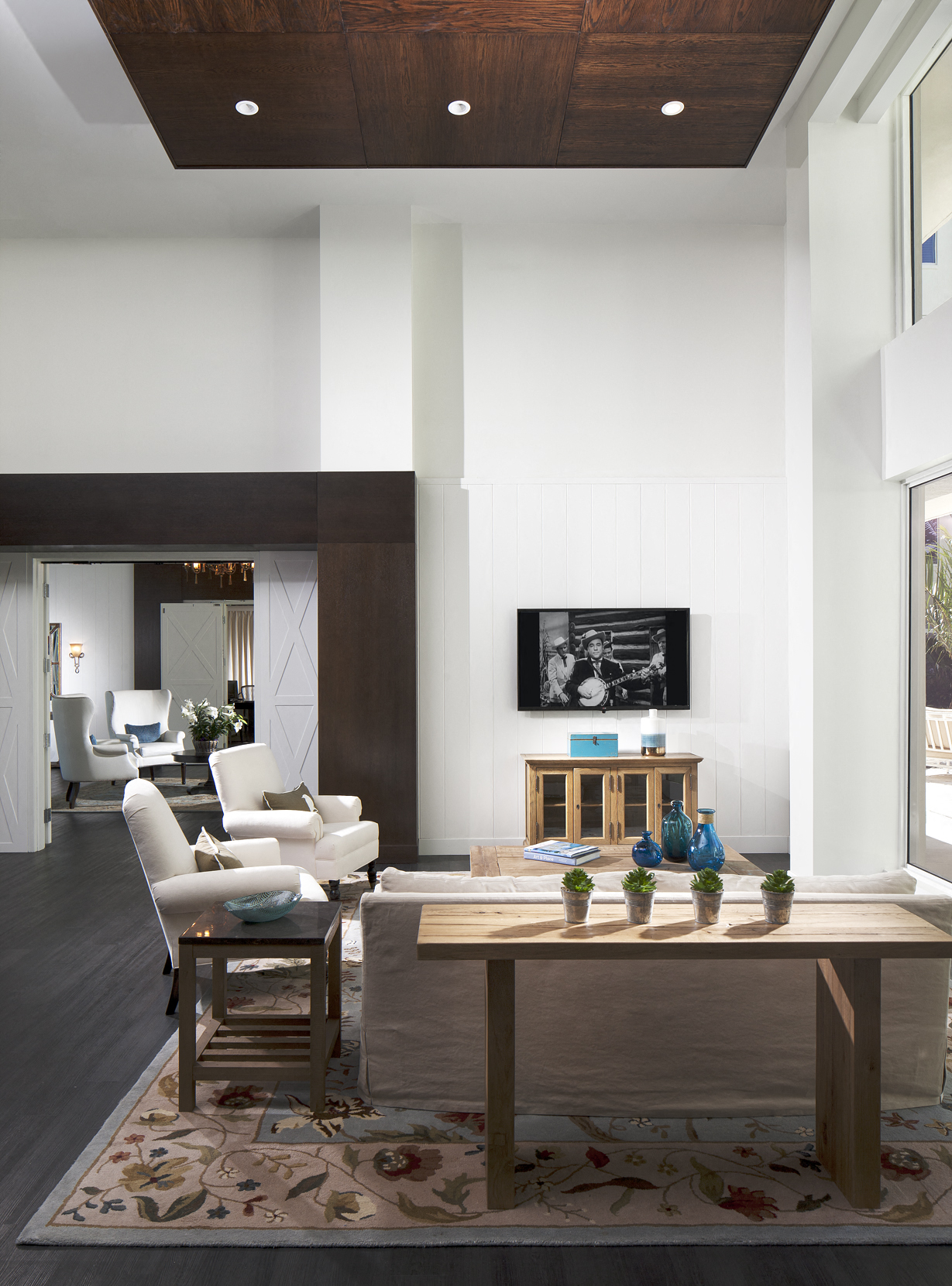 a living room with white walls and a wooden table