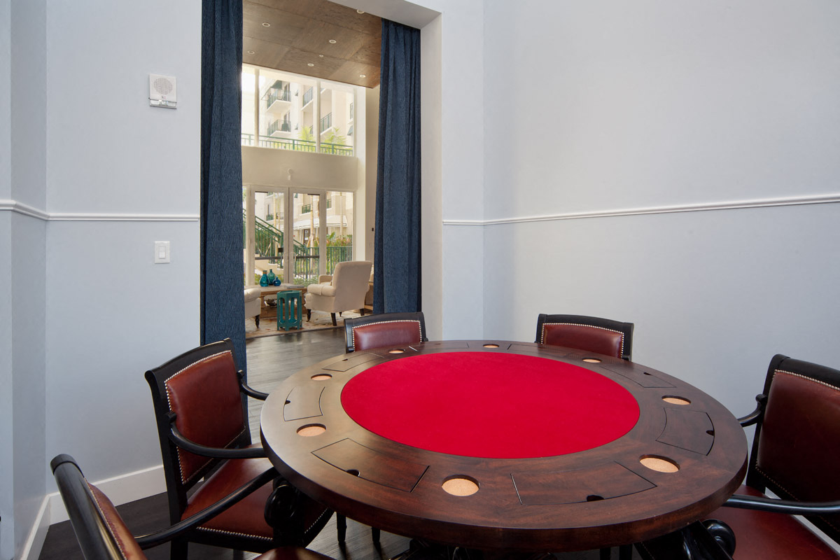 a dining room with a round table and chairs