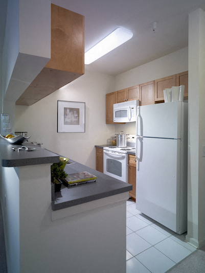 a kitchen with a white refrigerator and a sink