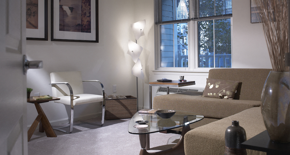 a living room with a couch and a table and a window