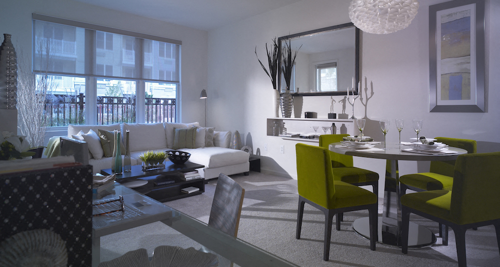 a living room and dining room with a table and chairs