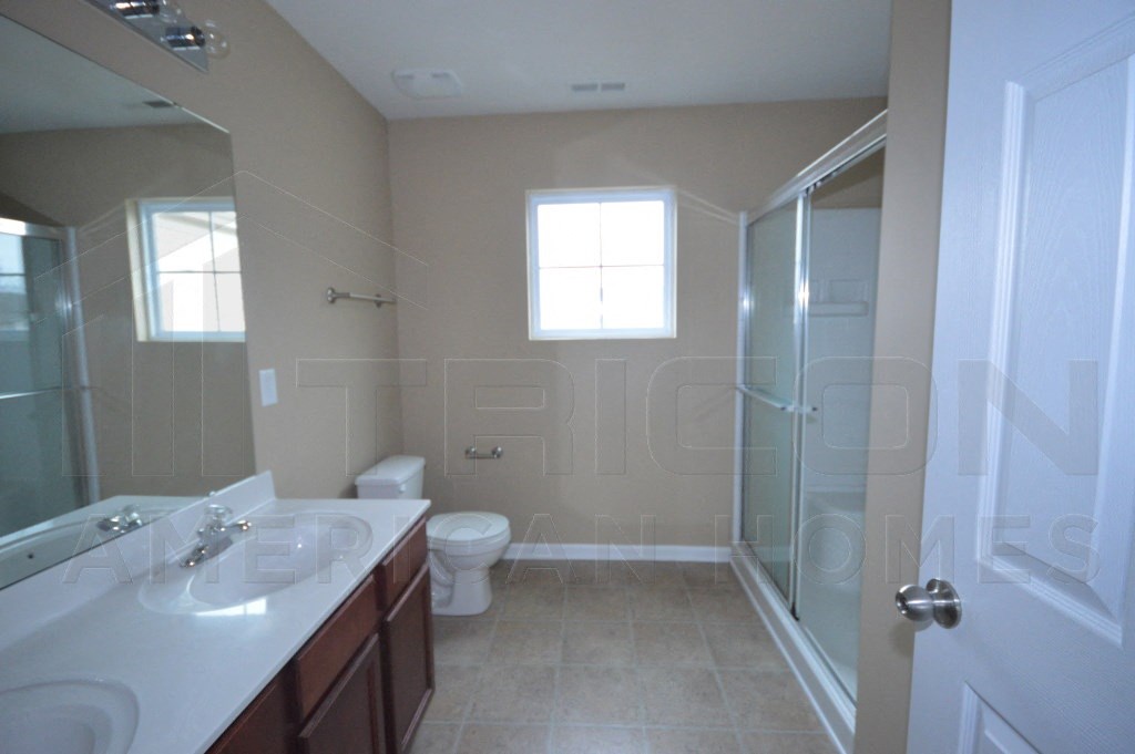 a bathroom with a shower toilet and a sink