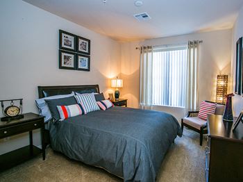 Spacious Model Apartment Bedroom with Carpet Flooring in Phoenix Suburb