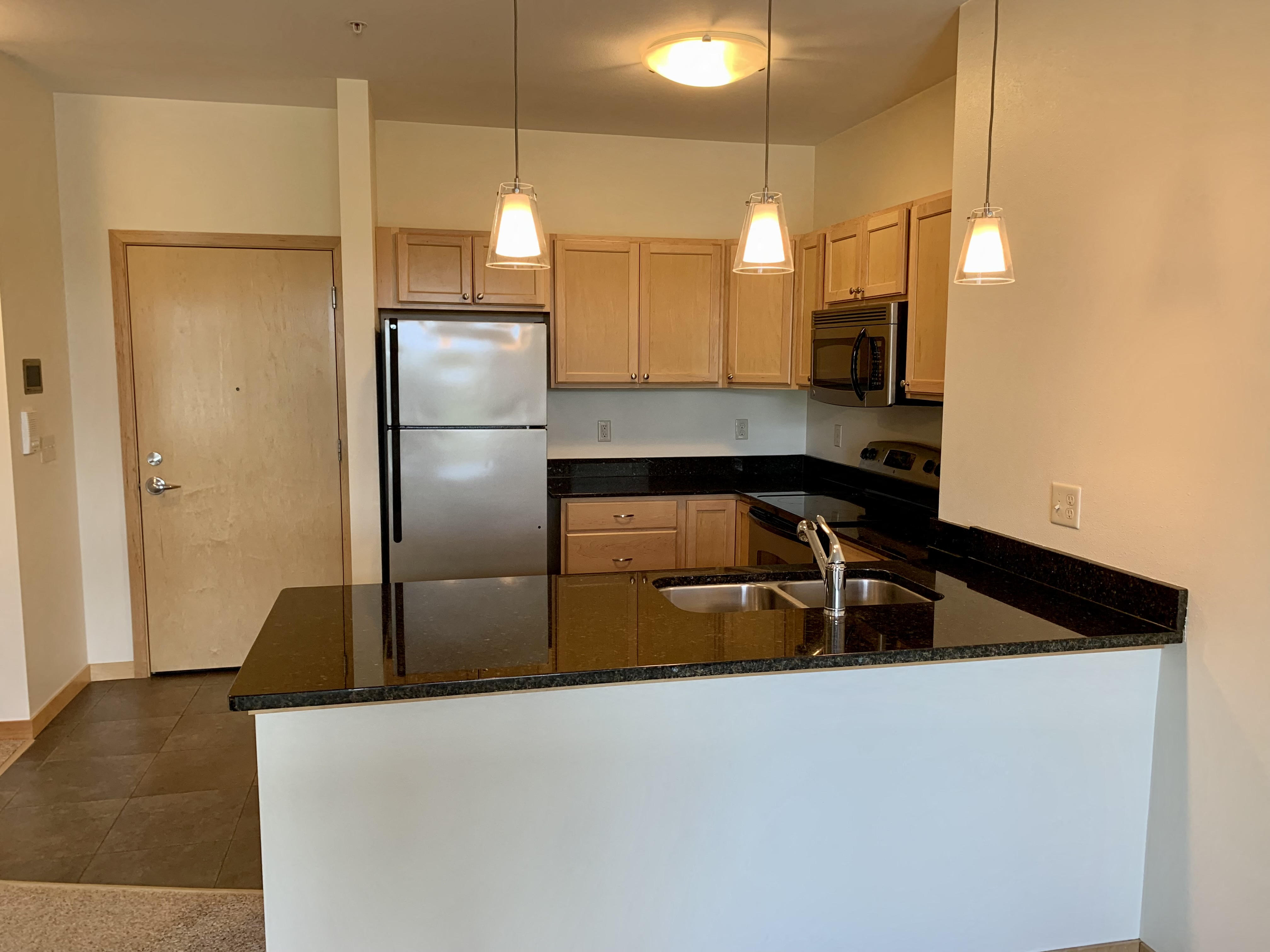 a kitchen with a counter top and a refrigerator