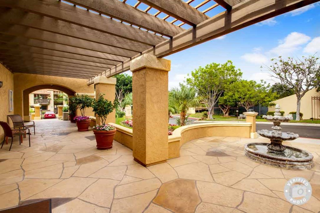 a patio with a fountain and a seating area