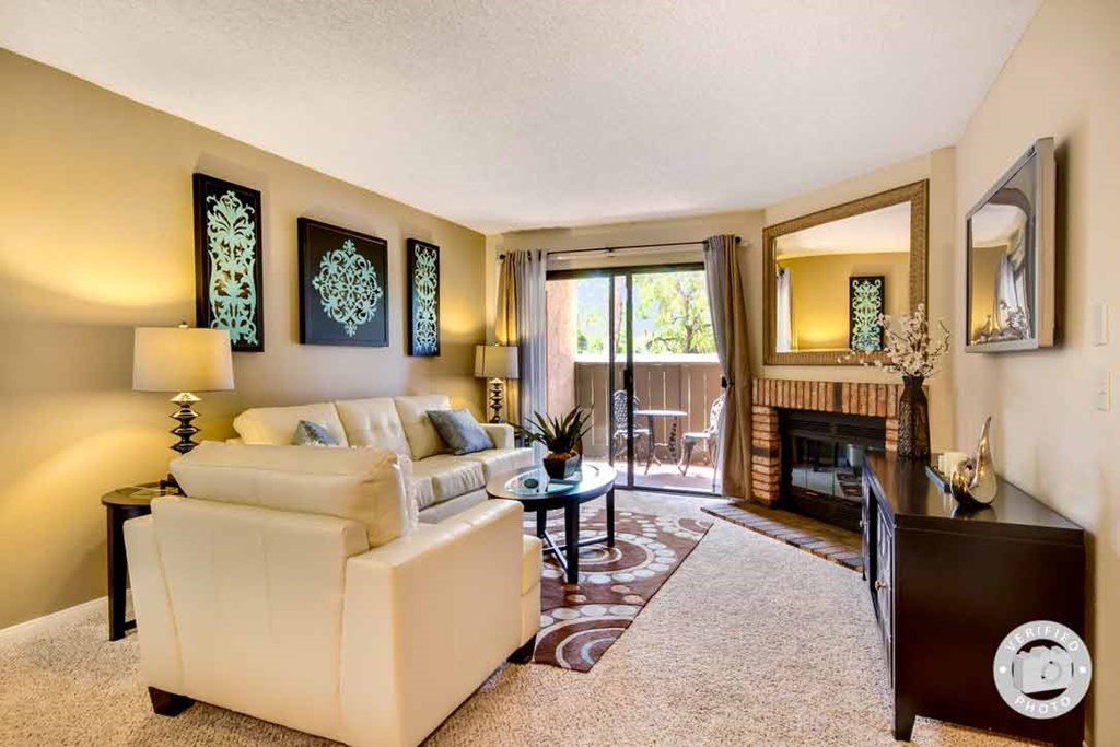 a living room with a couch and a tv and a fireplace