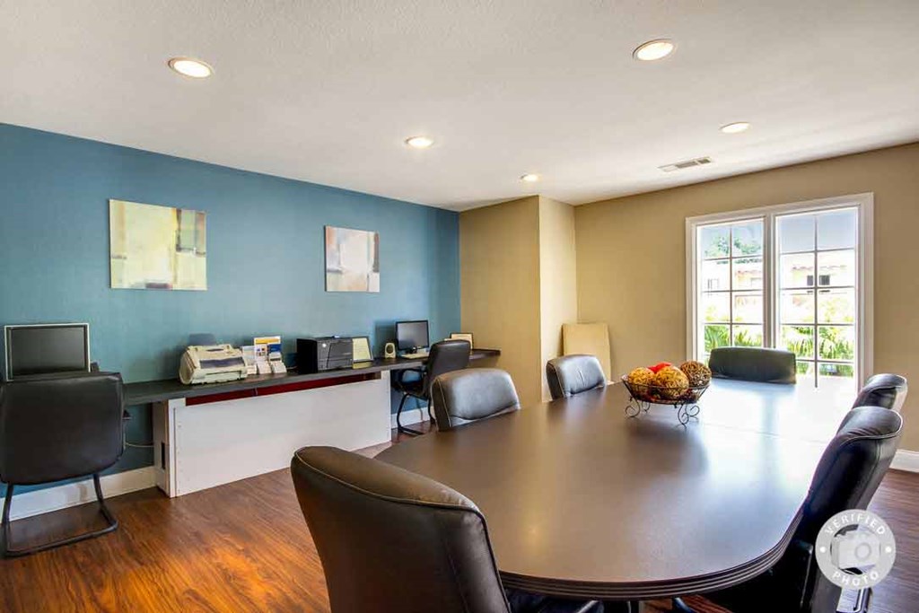 a conference room with a table and chairs
