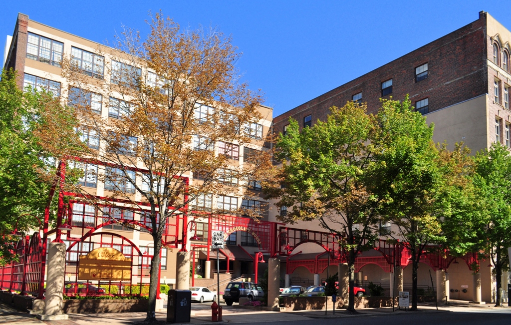 a view of a city street with buildings and trees